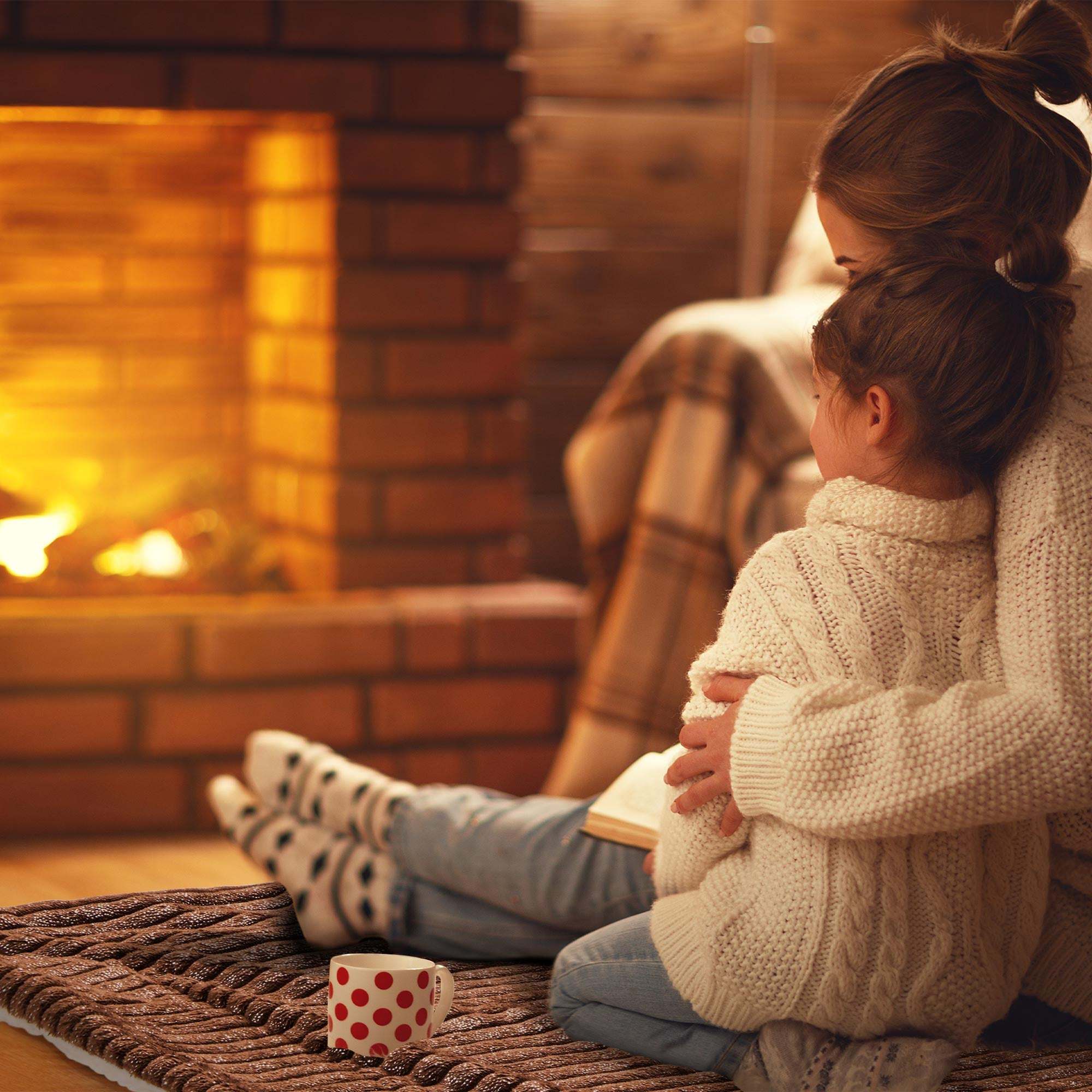 Cozy evening by the fireplace with a Beautissu Sherpa Kuscheldecke Elisa blanket.