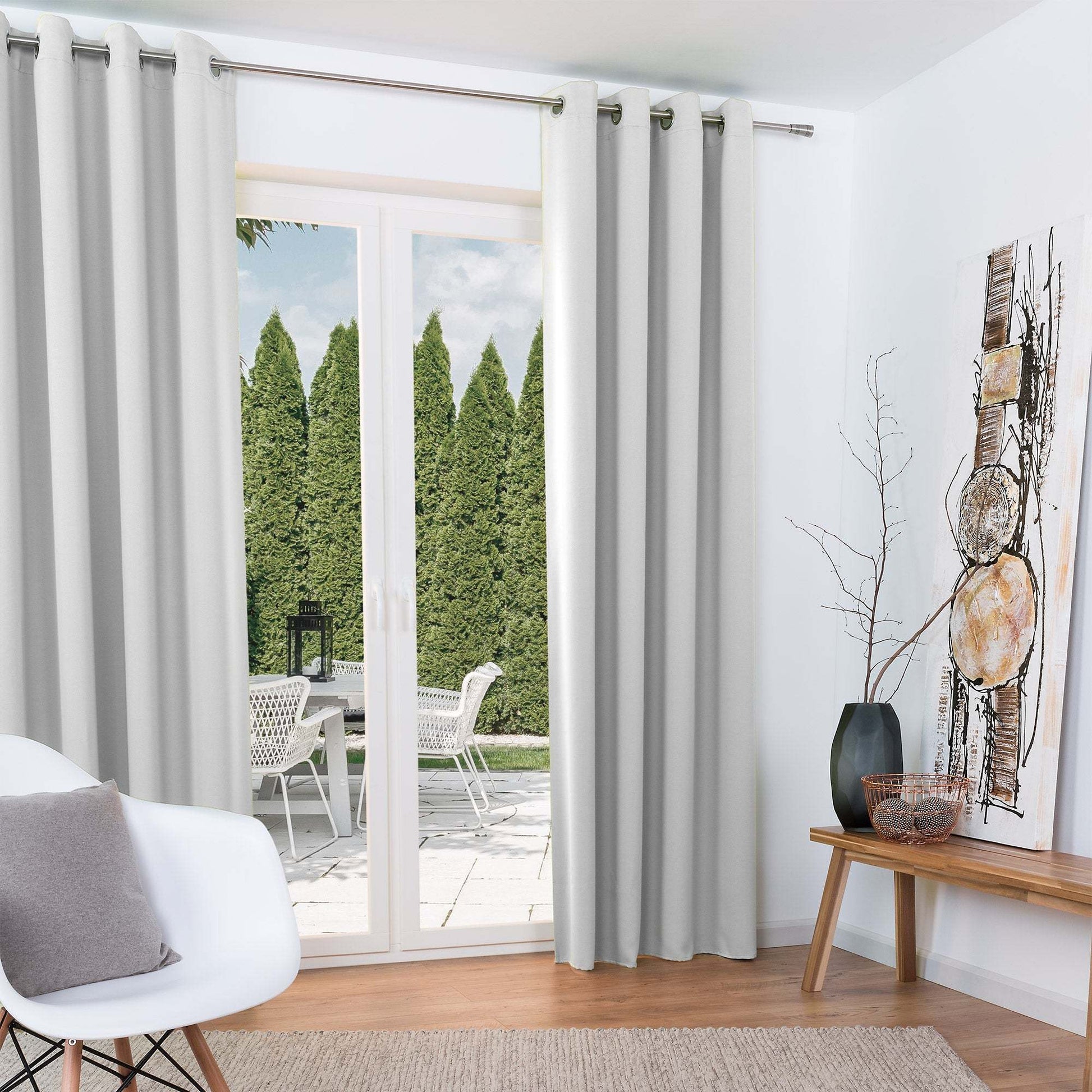 Beautissu Ösenschal Amelie blackout curtains hanging in a bright living room with a modern decor.