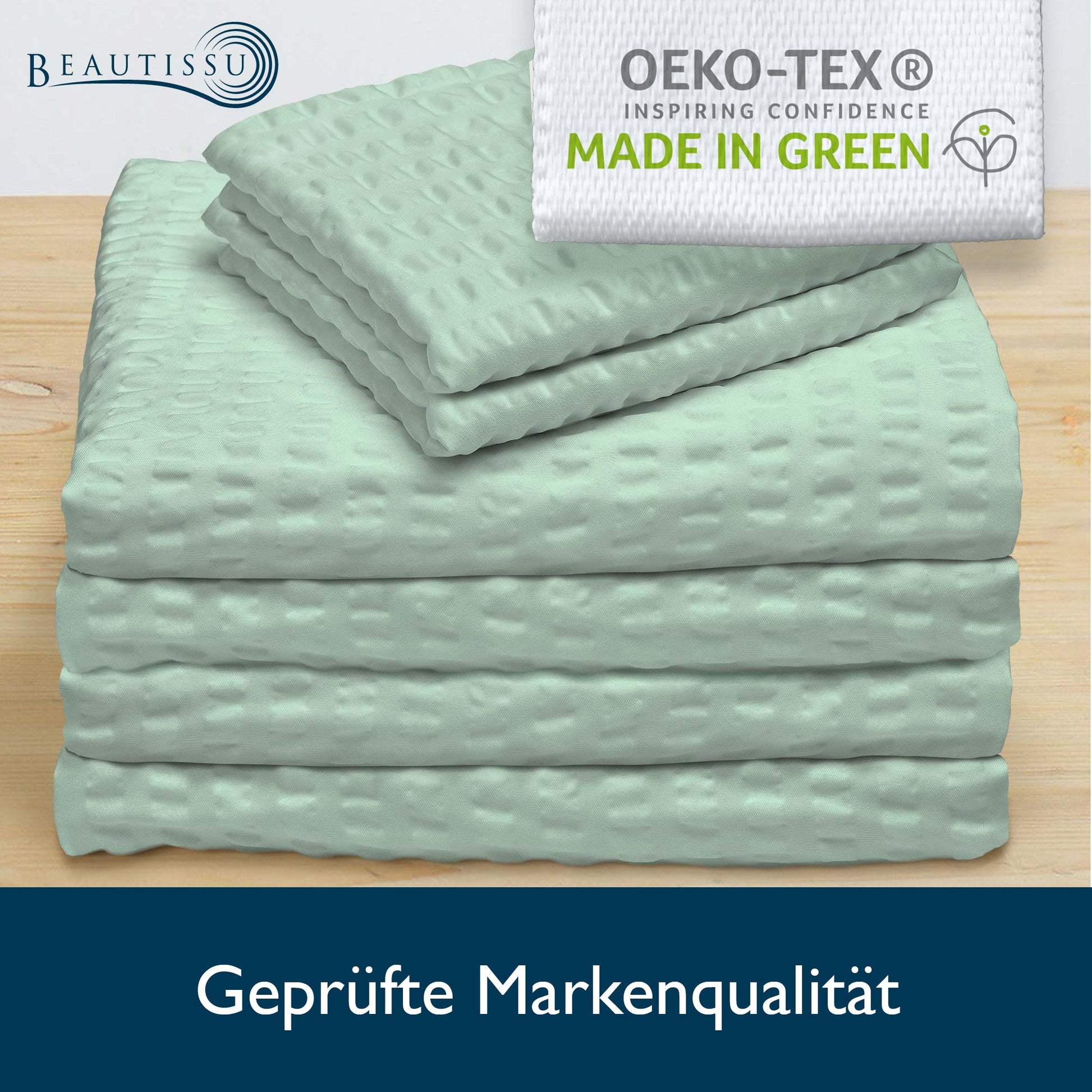 4-piece Beautissu Meline seersucker bedding set with Oeko-Tex label on wooden surface.