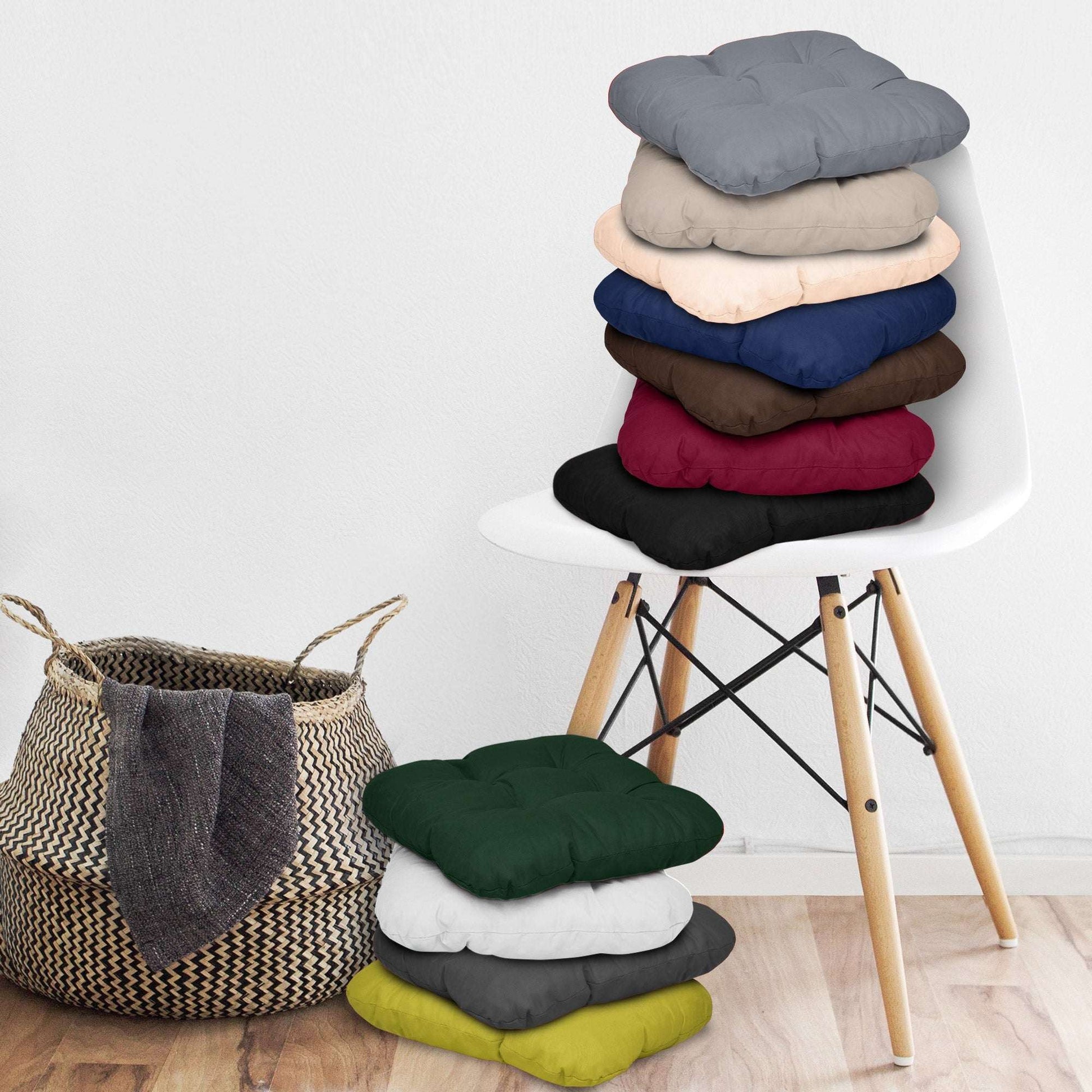 4er Set Beautissu Lisa chair cushions in various colors stacked on a chair.