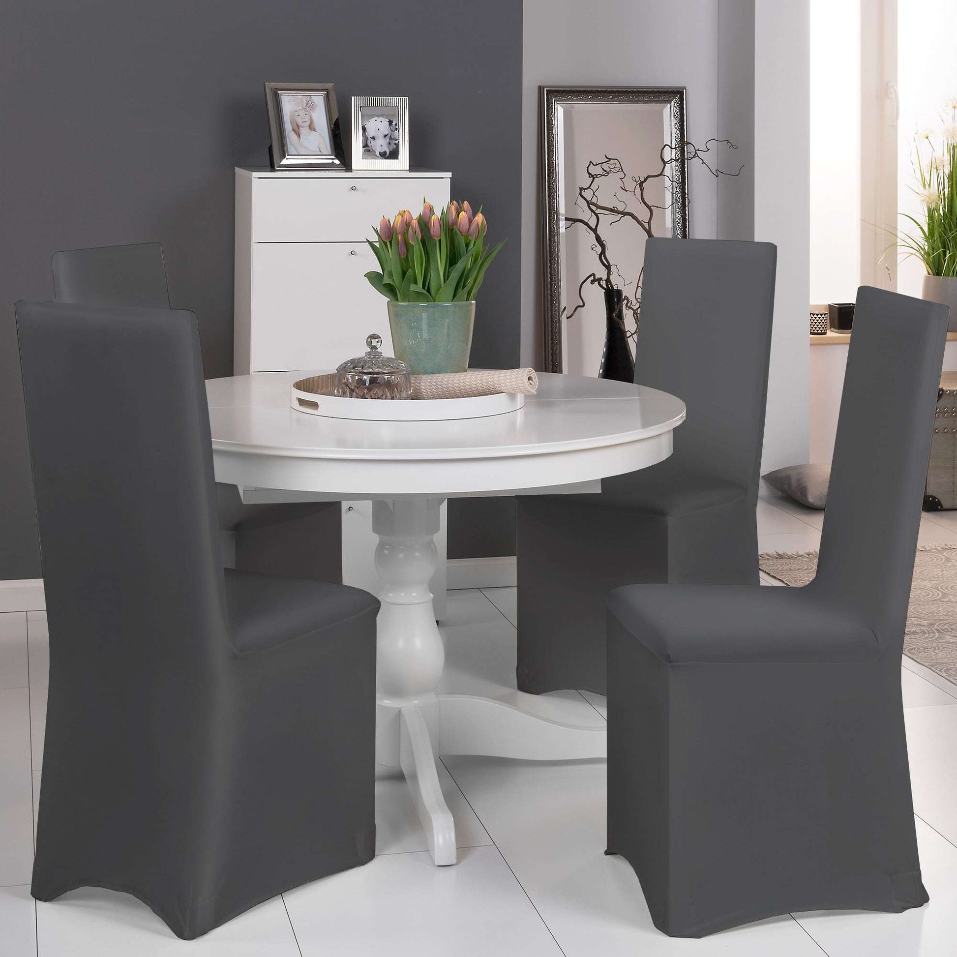 Beautissu Leona Stretch universal banquet chair cover in multiple colors, enhancing a dining room setting.