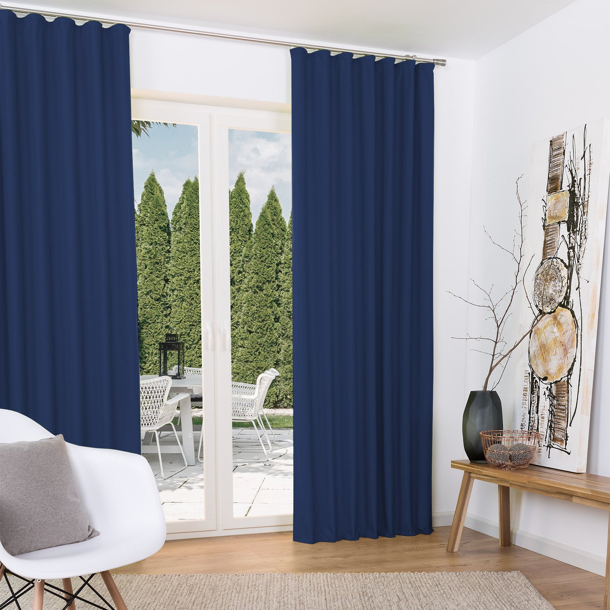 Beautissu Amelie thermal curtains with universal pleat tape, shown in a living room setting with a garden view.