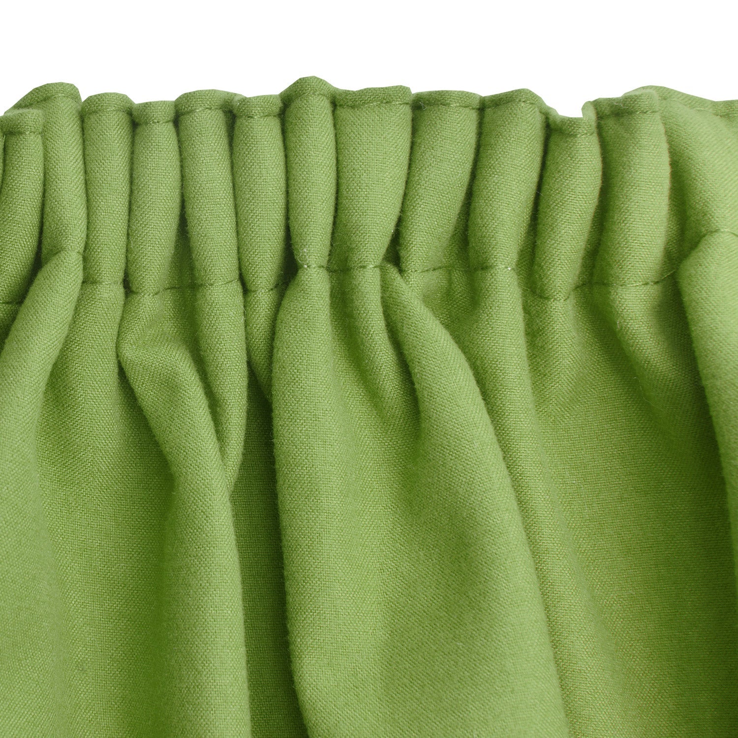 Green Beautissu Amelie thermal curtains with gathered header, highlighting their elegant folds and insulating properties.
